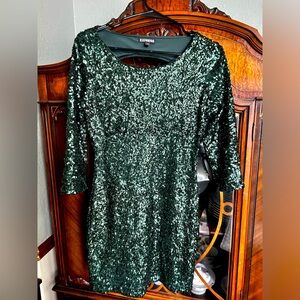 Green sparkly dress falls above the knee